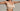 Woman wearing a nude colour wirefree bra set against a plain background