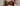 Black lace bra worn by a person on a neutral background