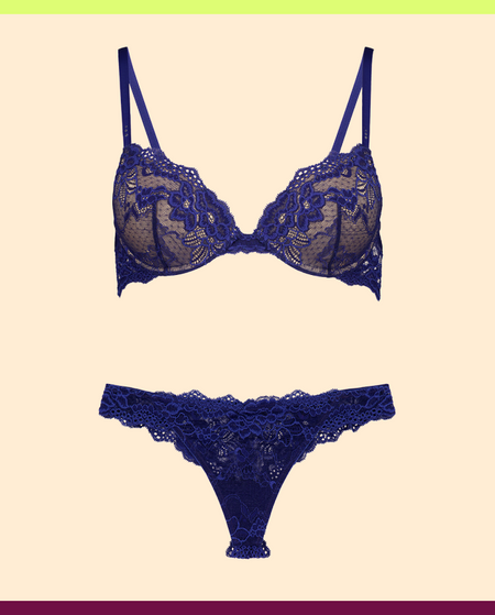Blue lace bra and panties set on a beige background