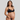 Pregnant woman wearing a black maternity bra and underwear set on a gray background
