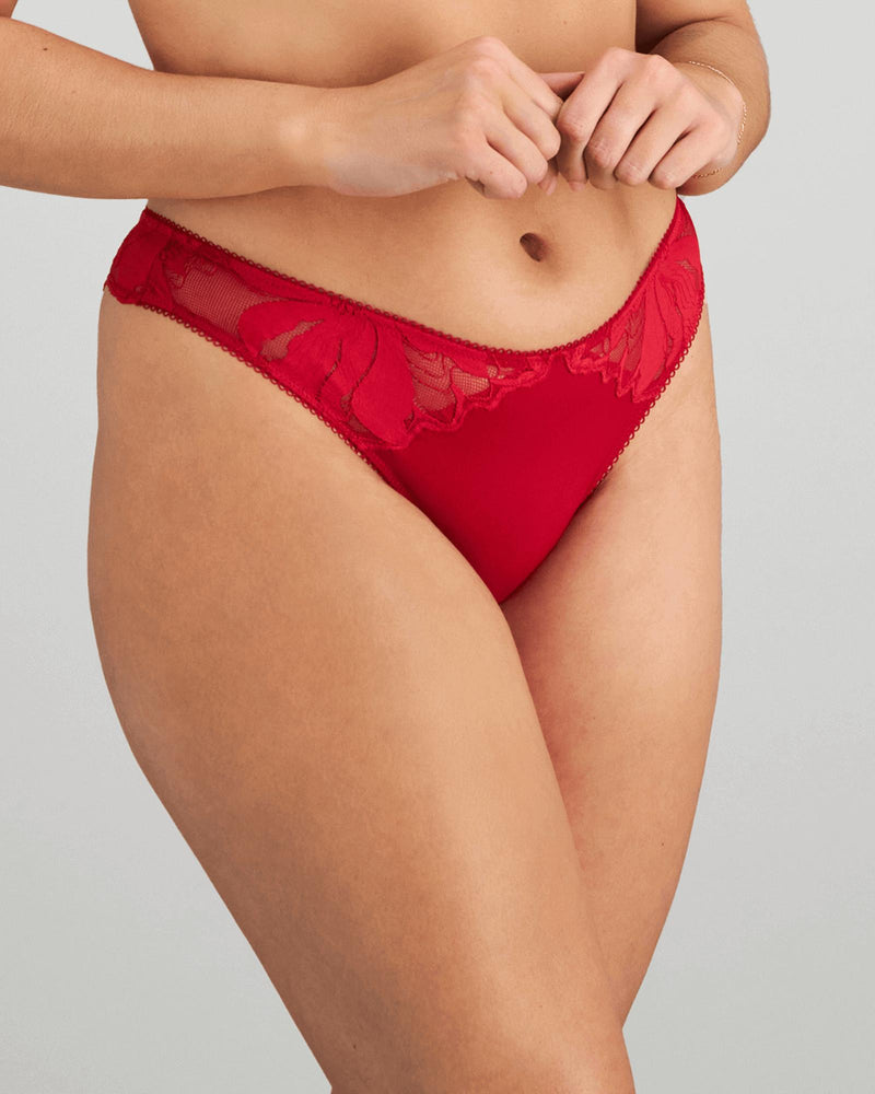 Model wears Margot Estelle Thong in JESTER RED. On body side view