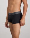Model wears Cotton Low-Rise Mens Trunk in BLACK. On body side view