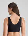 Model wears Comfit Collection Crop Top in BLACK. On body back view
