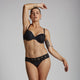 Model wears Captivate Me Bikini in BLACK. On body front view