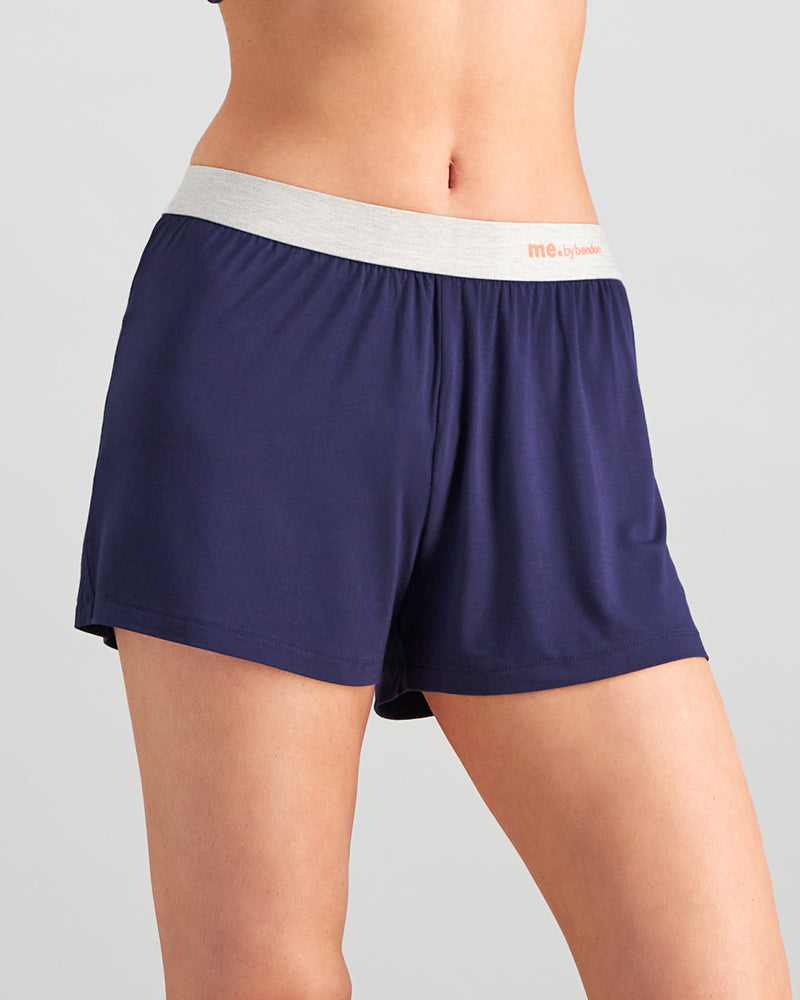 Model wears Belle Bamboo Short PJ in EVENING BLUE. On body side view