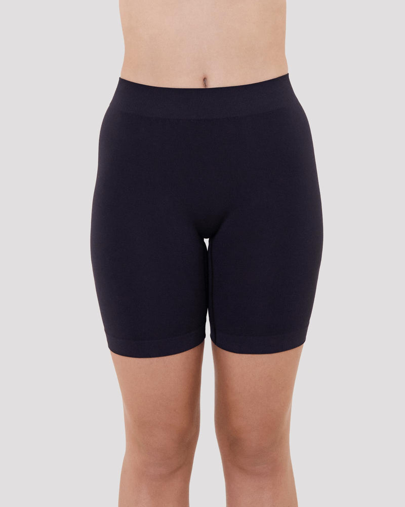 Model wears Smoothing Bodywear Chafer Short in BLACK. On body front view