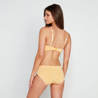 Model wears Simply Seamless Wire Free Bra in DAFFODIL MARL. On body back view