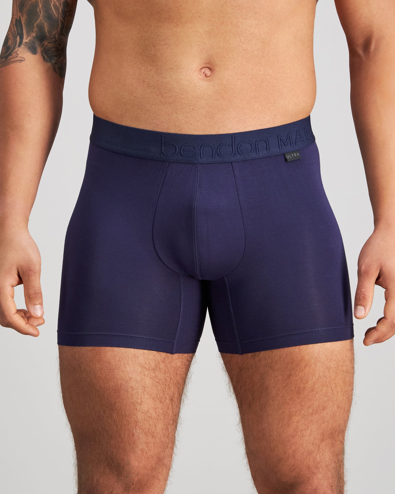 Model wears Bamboo Mens Trunk in PEACOAT. On body front view