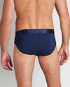 Model wears Bamboo Mens Brief in Medieval Blue. On body back view