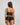 Model wears Oasis Glow Camisole in BLACK. On body back view