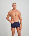 Model wears High Tech Cotton Mens Trunk in PEACOAT. On body front view