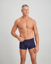 Model wears High Tech Cotton Mens Trunk in PEACOAT. On body front view