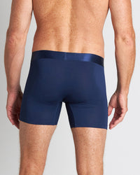 Model wears Bamboo Mens Trunk in Medieval Blue. On body back view