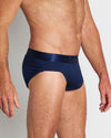 Model wears Bamboo Mens Brief in Medieval Blue. On body side view