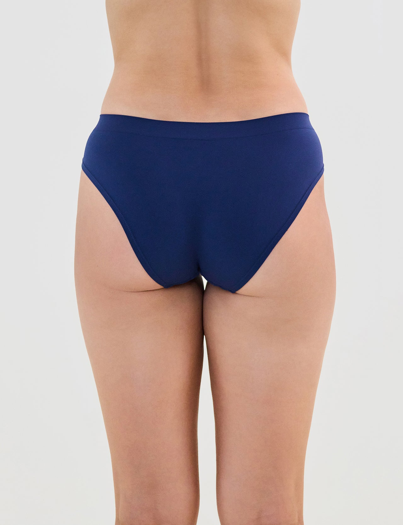 Model wears Seamless Soft Bikini in Medieval Blue. On body back view