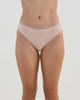 Model wears Stretch Cotton Thong in LATTE. On body front view