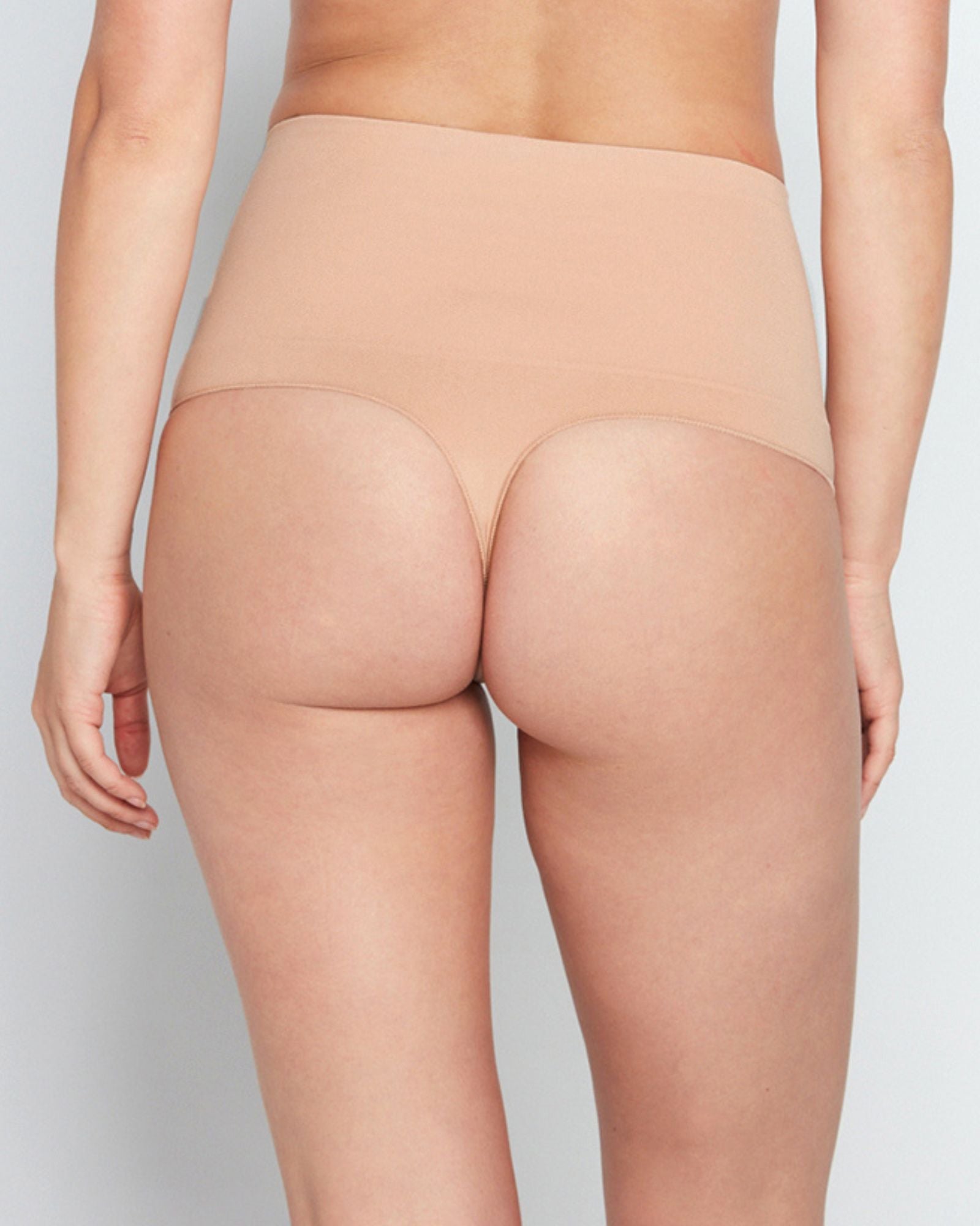Model wears Bamboo Bodywear Thong in CARAMEL. On body back view