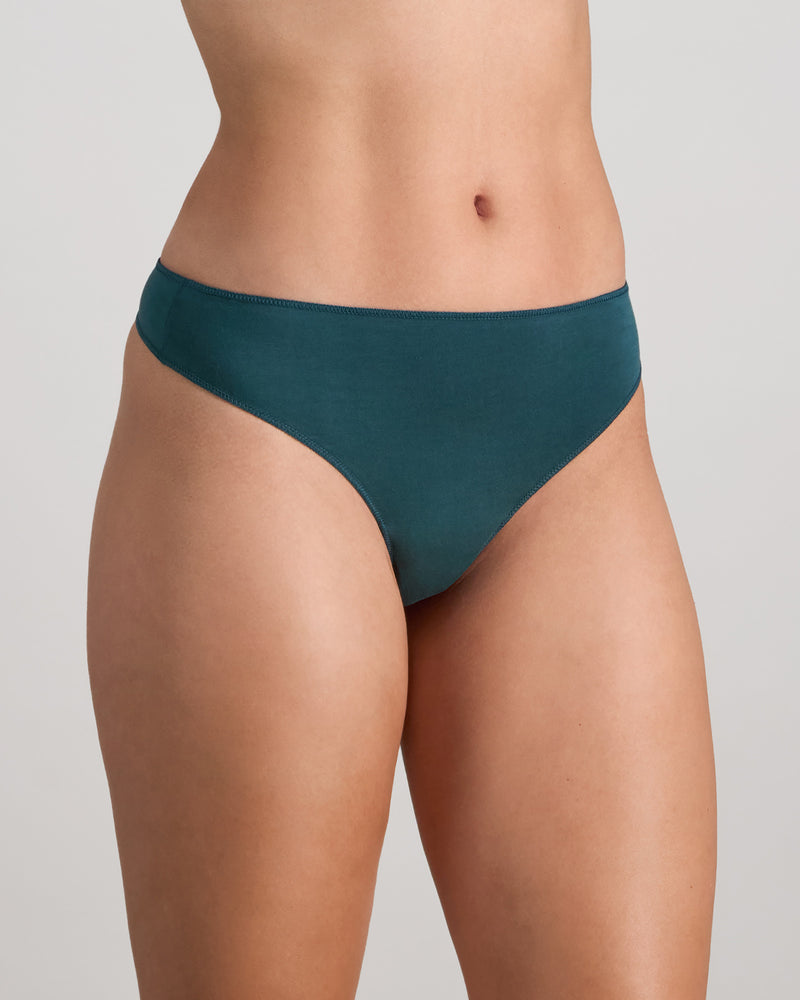 Model wears Au Naturel Thong in MEDITERRANEA. On body side view