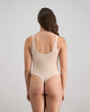 Model wears Extra-Ordinary Bodysuit in LATTE. On body back view