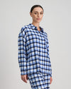 Model wears Cosy Flannel Long Sleeve PJ Top in BLUE CHECK. On body side view