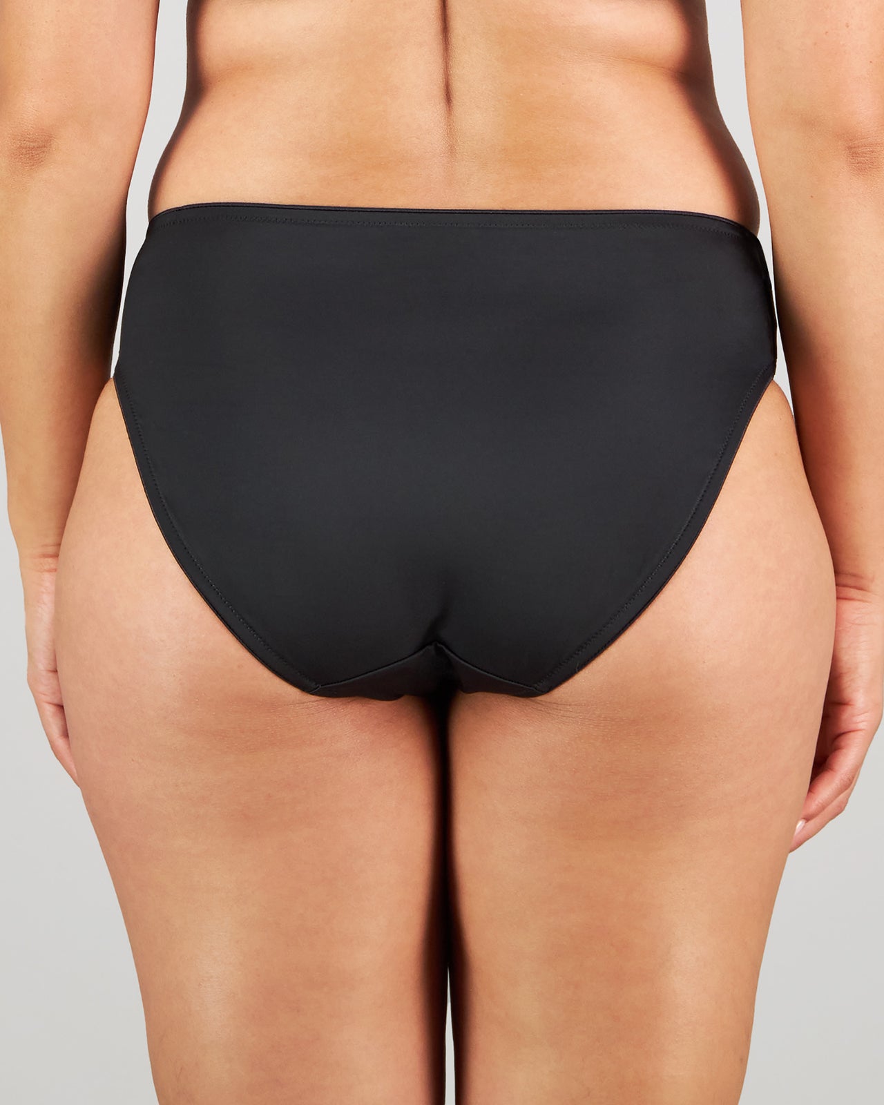 Model wears Magnetism High Cut Brief in BLACK/LATTE. On body back view