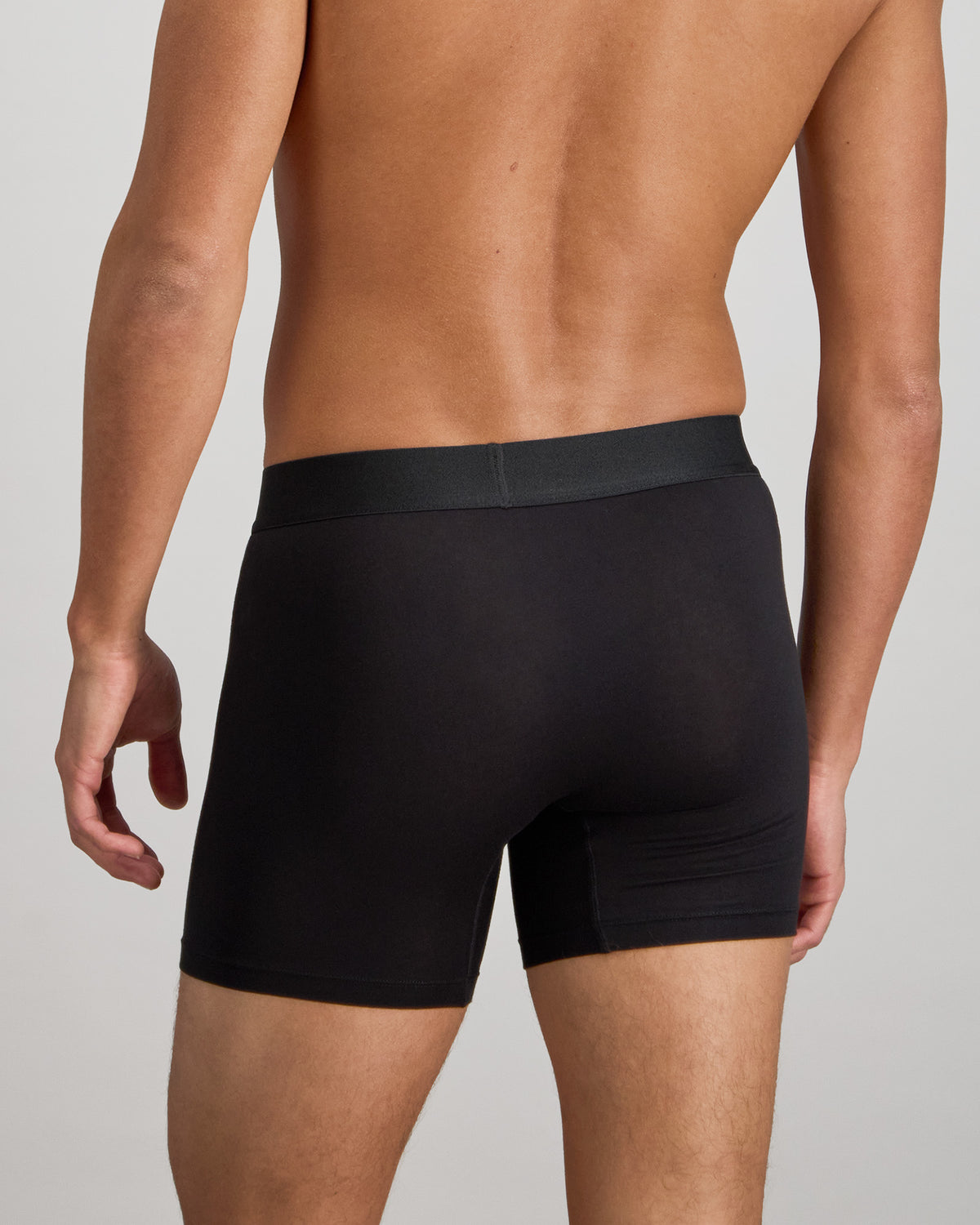 Model wears Bamboo Mens Trunk in BLACK. On body back view