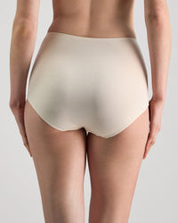 Model wears Freestyle Full Brief in CHAMPAGNE. On body back view