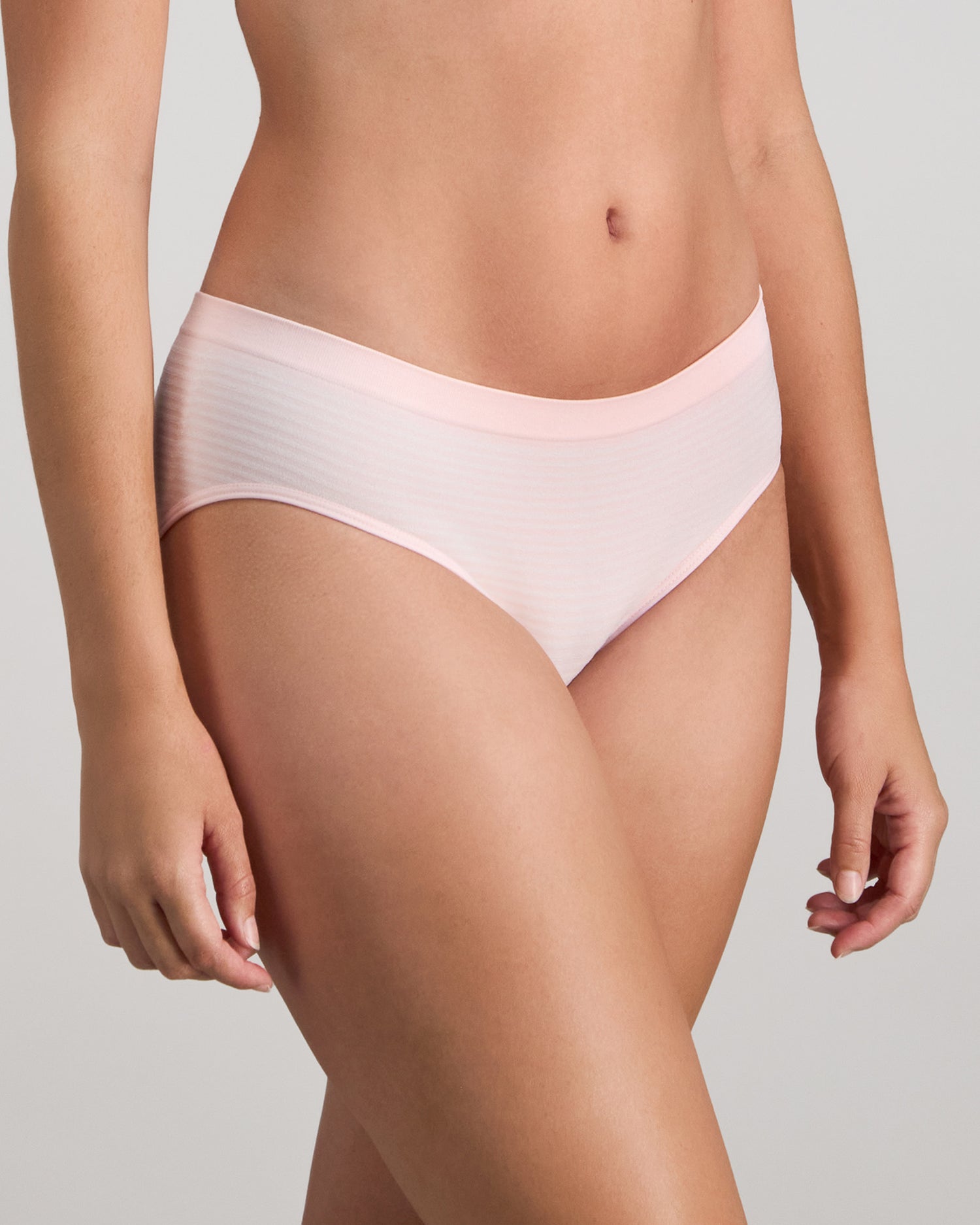 Model wears Simply Seamless Boyshort in ICY PINK/WHITE STRIPE. On body side view