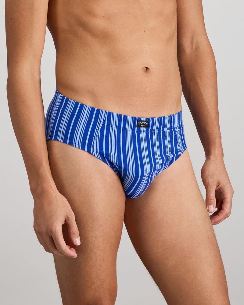 Model wears Cotton Stretch Mens Brief in SURF THE WEB STRIPE. On body side view
