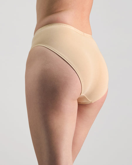 Model wears Body Cotton High Cut Brief in NATURAL. On body side view