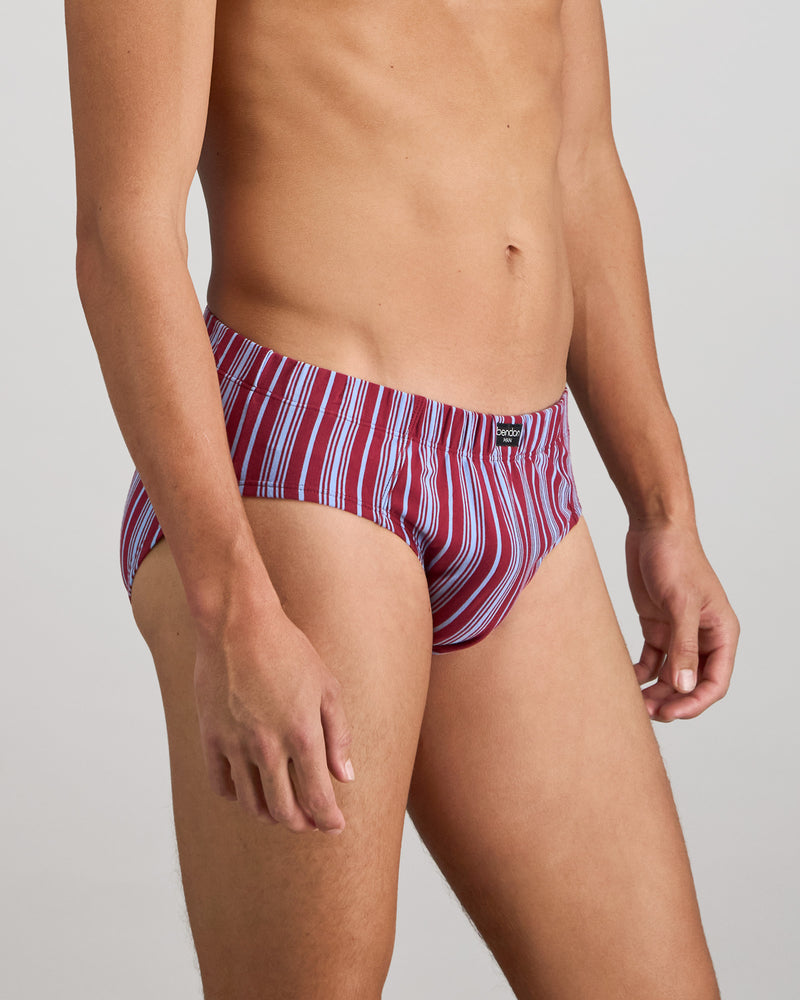 Model wears Cotton Stretch Mens Brief in TIBETAN RED STRIPE. On body side view