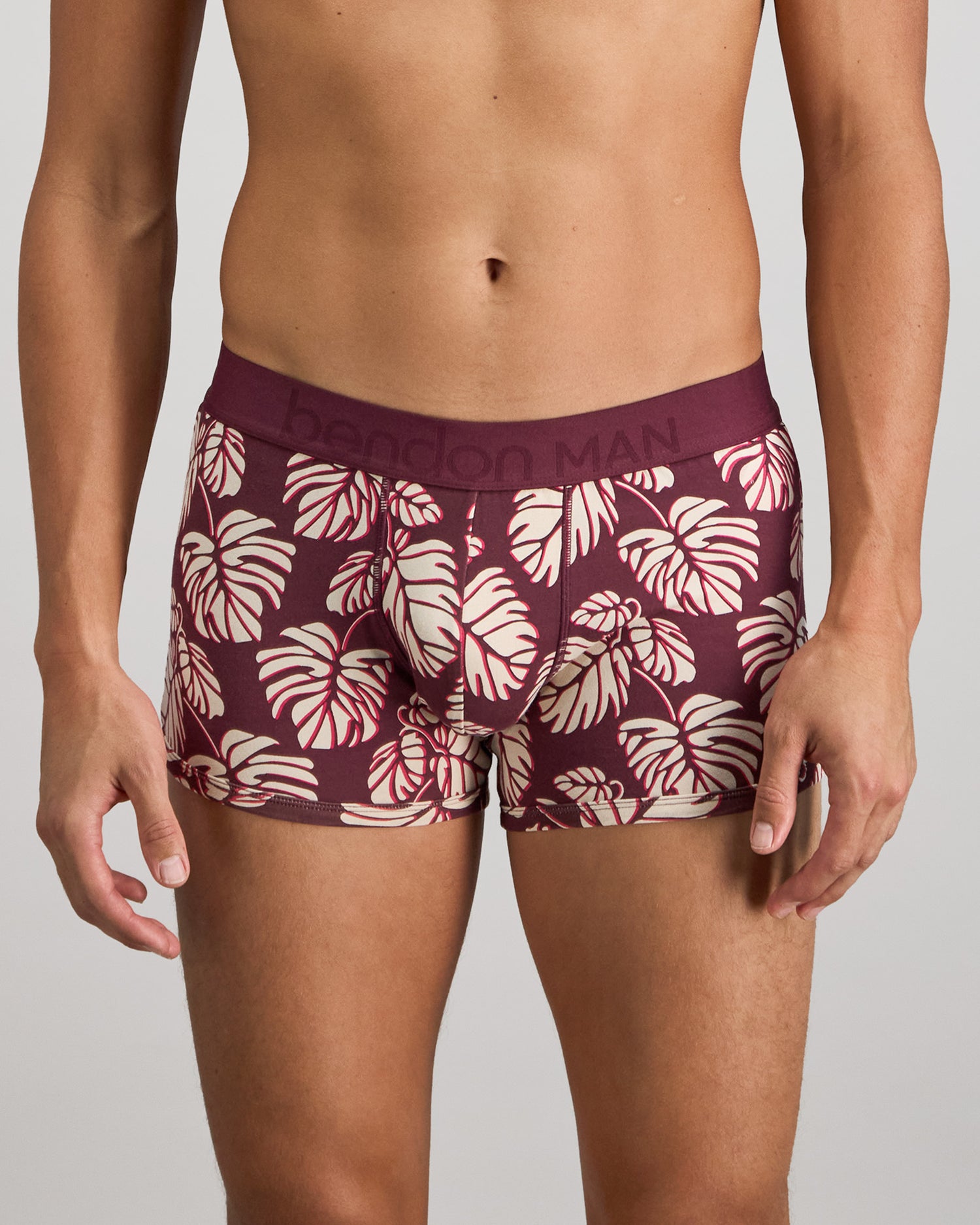 Model wears Retros Print Mens Trunk in FIG MONSTERA PRINT. On body front view