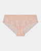Model wears Lace Trim Brazilian in LATTE. On body front view