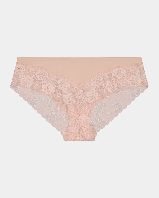 Model wears Lace Trim Brazilian in LATTE. On body front view