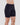 Model wears Smoothing Bodywear Chafer Short in BLACK. On body side view
