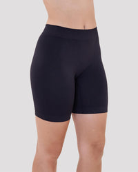 Model wears Smoothing Bodywear Chafer Short in BLACK. On body side view