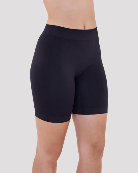 Model wears Smoothing Bodywear Chafer Short in BLACK. On body side view
