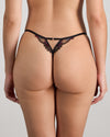 Model wears Niara Thong in BLACK/BEAUJOLAIS. On body back view