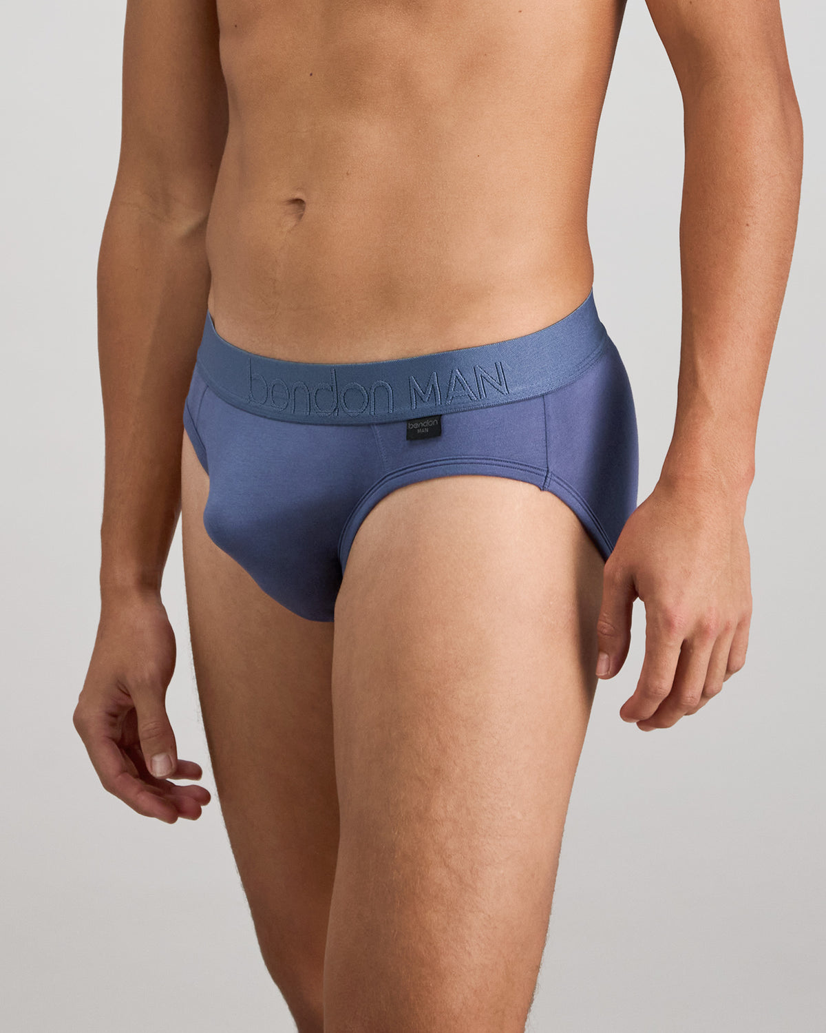 Model wears Bamboo Mens Brief in VINTAGE INDIGO. On body side view