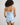 Model wears Sweet Indulgence Cami & Short Set in SKYWAY/WHITE. On body back view
