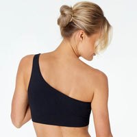 Model wears Lola Rib Crop Top in BLACK. On body back view