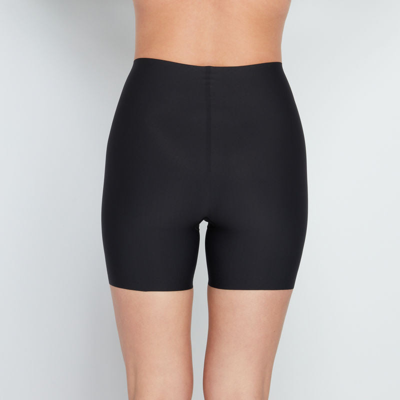 Model wears Everyday Light Hold Chafer Short in BLACK. On body back view