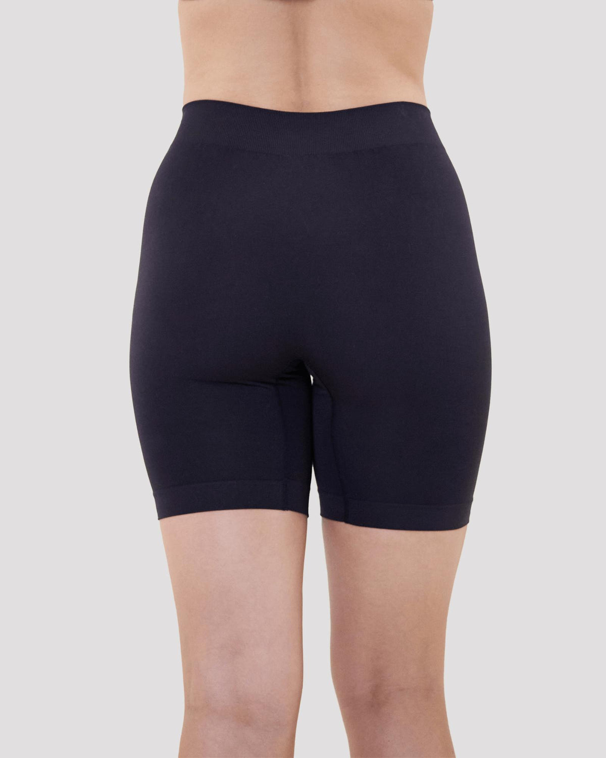 Model wears Smoothing Bodywear Chafer Short in BLACK. On body back view
