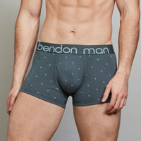 Model wears Cotton Print Series Mens Trunk in NATURE PRINT CHINA BLUE. On body side view
