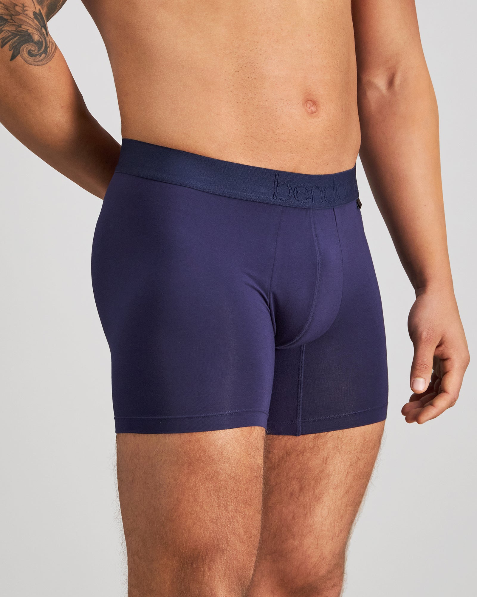 Model wears Bamboo Mens Trunk in PEACOAT. On body side view