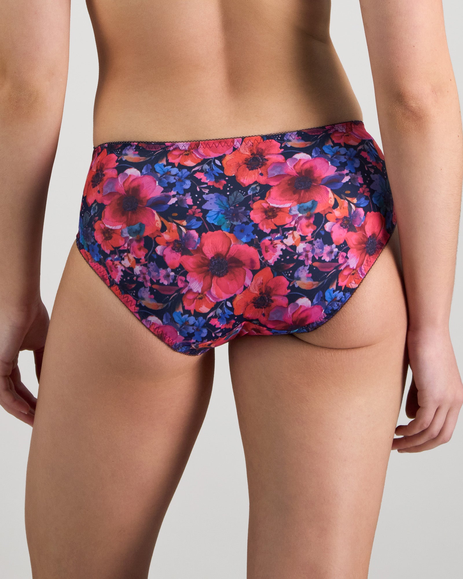 Model wears Wild Violet Full Brief in JAZZY FLORAL PRINT. On body back view