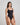 Model wears Extra-Ordinary Bodysuit in BLACK. On body side view