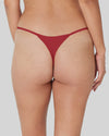 Model wears Clemence Thong in JESTER RED. On body back view
