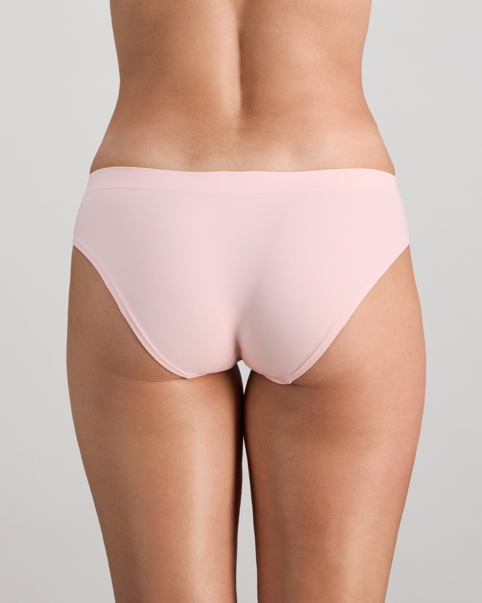 Model wears Seamless Soft Bikini in ICY PINK. On body back view