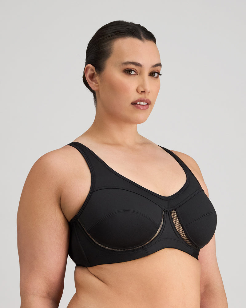 Model wears Bendon Sports Underwire Bra in BLACK. On body side view